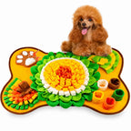 Poodle using a yellow and orange snuffle mat for food enrichment