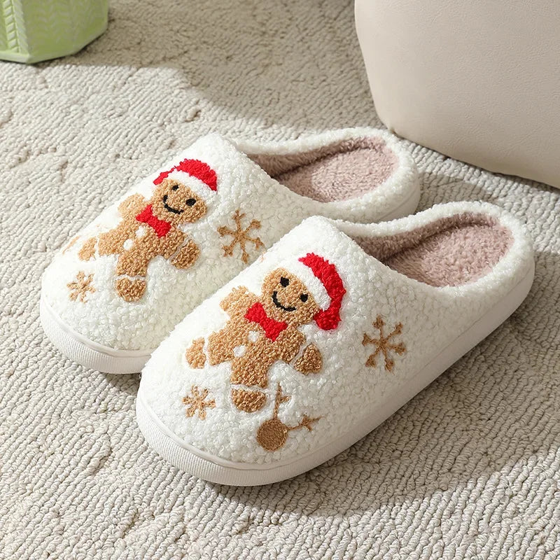 Pair of white slippers with gingerbread man design on a textured surface