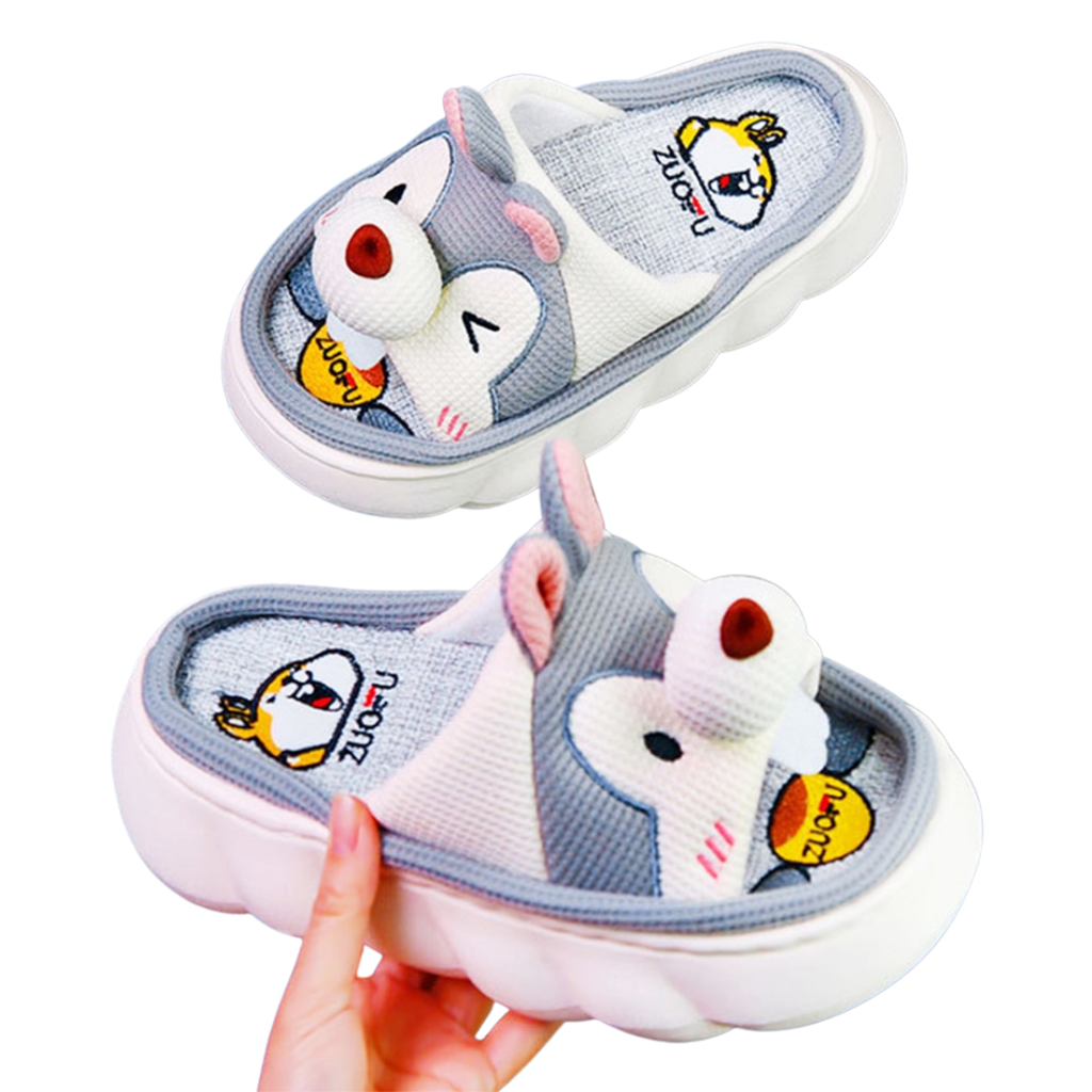 Pair of cartoon Gray Squirrel character slippers with a hand holding one shoe.