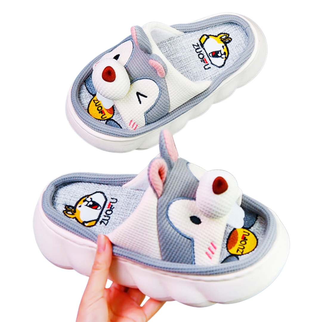 Pair of cartoon Gray Squirrel character slippers with a hand holding one shoe.