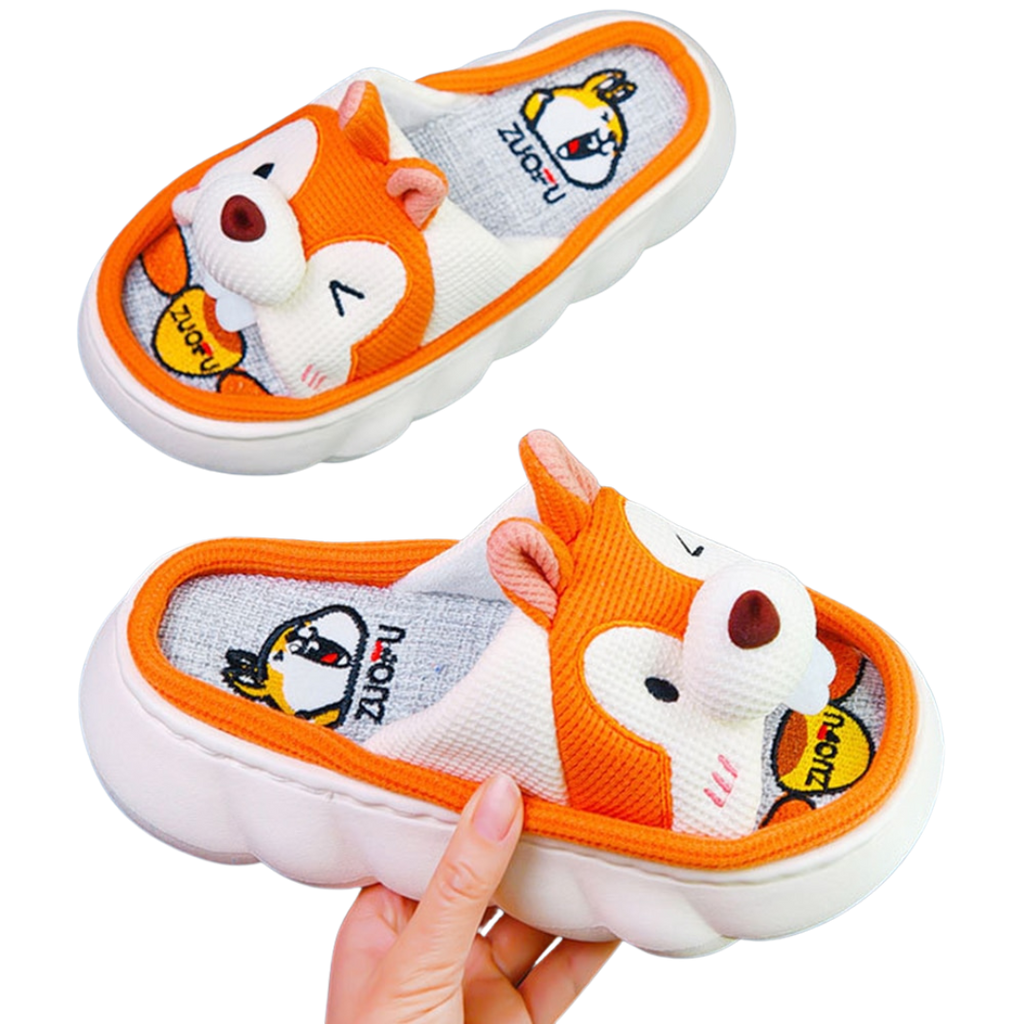 Children's cartoon Orange Squirrel slippers with a fox design held by a hand on a white background
