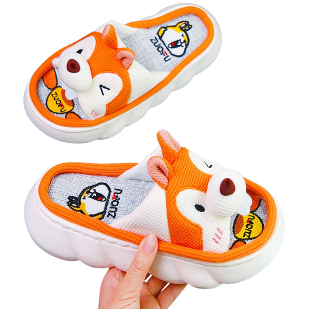 Children's cartoon Orange Squirrel slippers with a fox design held by a hand on a white background