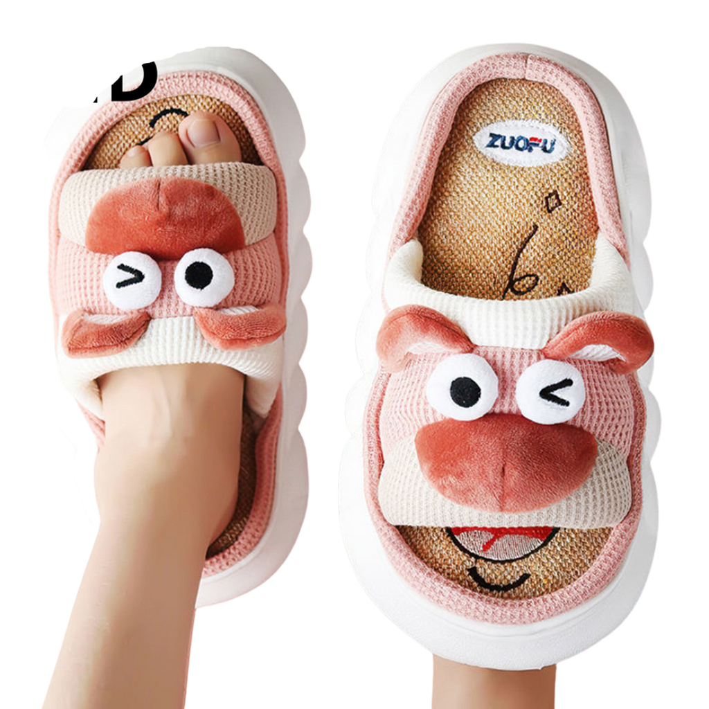 Pair of cartoon pink bear slippers with a smiling face design on a white background