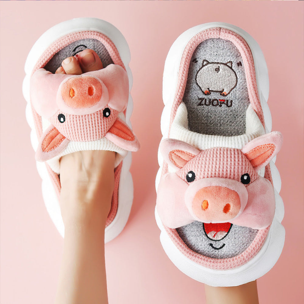 Pair of pink pig-themed slippers with 'ZUOFU' branding on a pink background