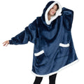 Person wearing a blue fleece poncho with white trim on a white background